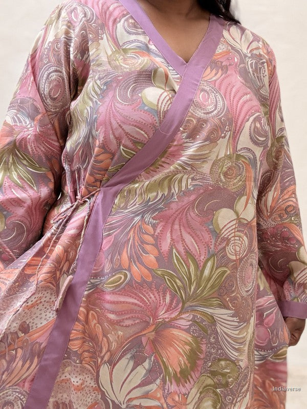 front close up of a wrap dress that is tied up on the side in purple pink colors