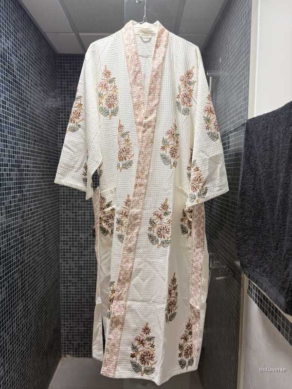 Floral patterned robe hanging against a tiled wall
