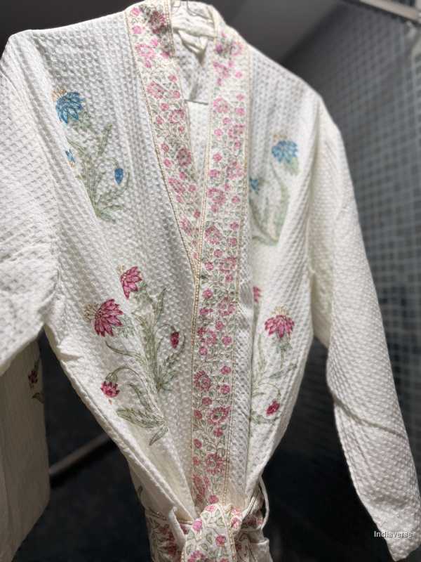 Floral embroidered garment on a hanger with a blurred background