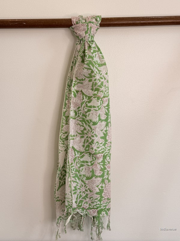 cotton scarf with green and white floral design tied to a wooden beam