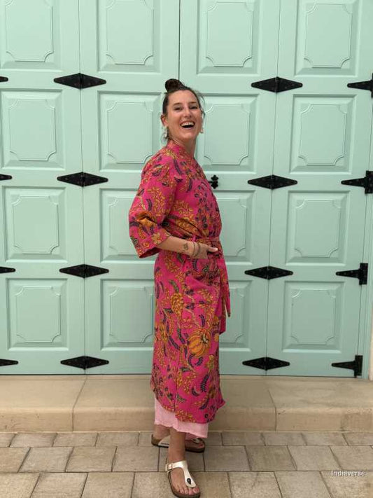 Model wearing a hot pink waffle cotton bathrobe with a relaxed fit, tie belt, and pockets, showcasing the lightweight and breathable fabric.