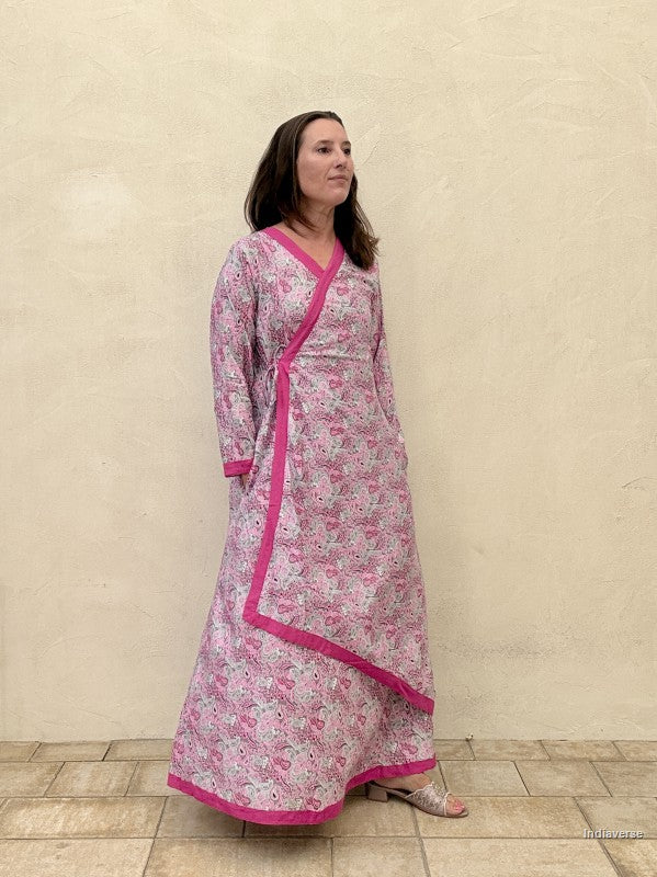 Woman wearing a pink floral dress with a white background