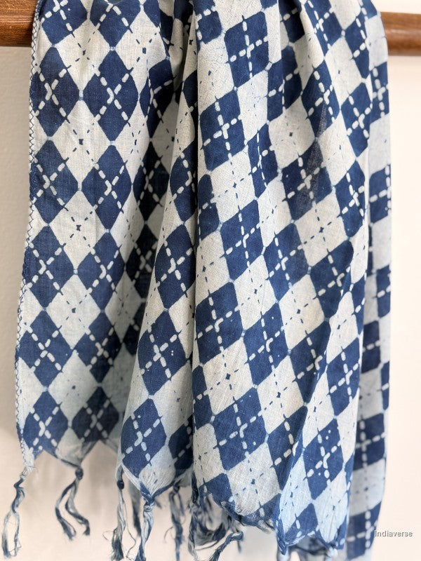 Blue and white checkered scarf with fringes on a wooden rod against a white background