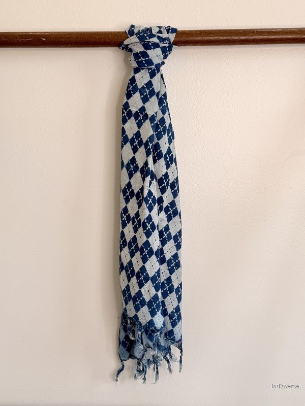 Blue and white checkered scarf with fringes on a wooden rod against a white background