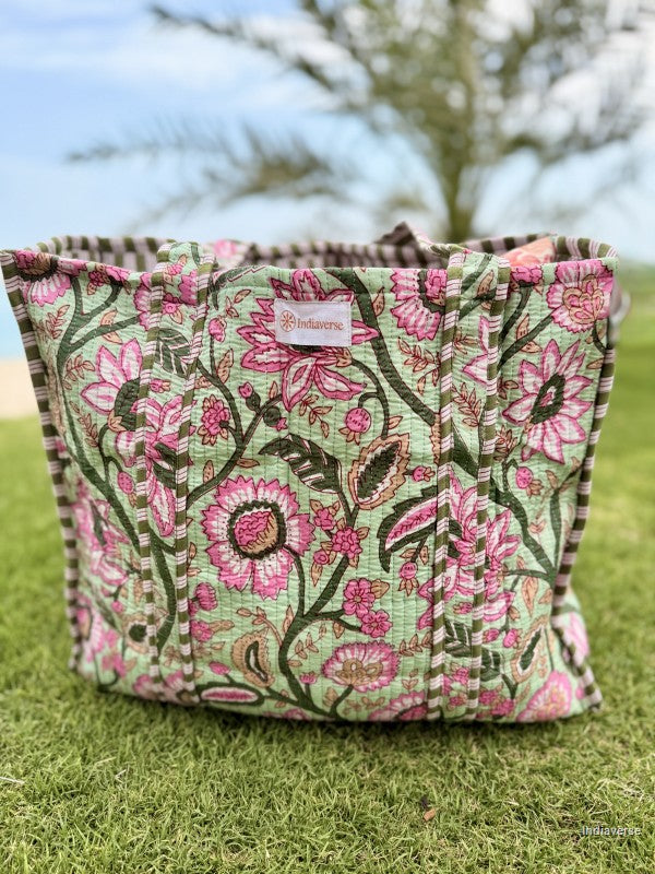 Floral patterned fabric basket on grass with blurred background