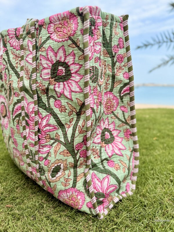 Floral-patterned fabric on grass with a blurred natural background
