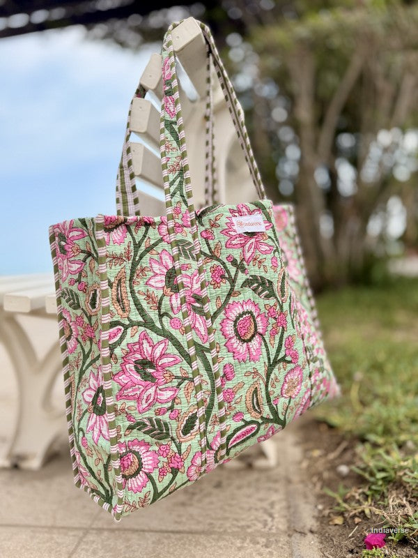 Floral patterned tote bag on a stone surface with a blurred natural background