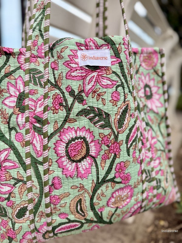 Floral patterned bag with 'Indiaverse' branding on a blurred background