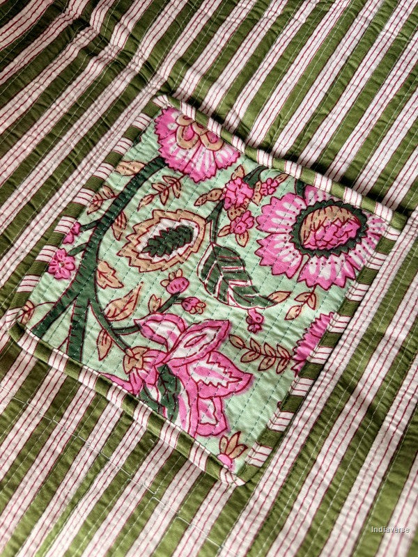 Floral patch inside pocket on a green and white striped fabric background