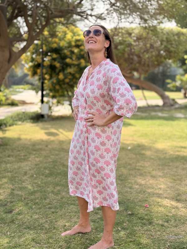 Woman in a floral dress standing in a park