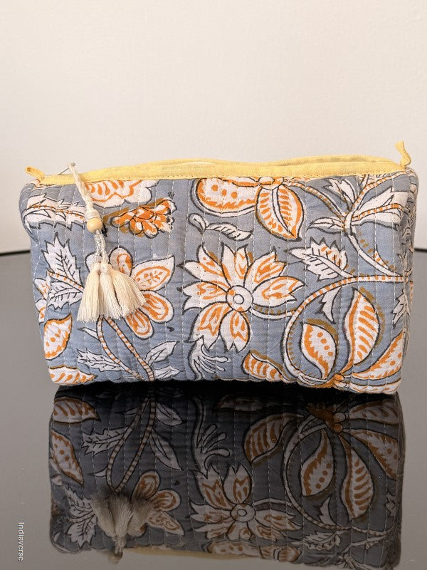 Two fabric bags with floral patterns on a plain background