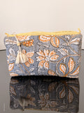 Two fabric bags with floral patterns on a plain background