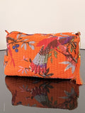 Two folded fabric pieces with floral patterns on a plain background