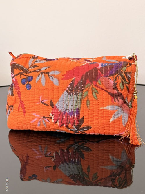 Two folded fabric pieces with floral patterns on a plain background