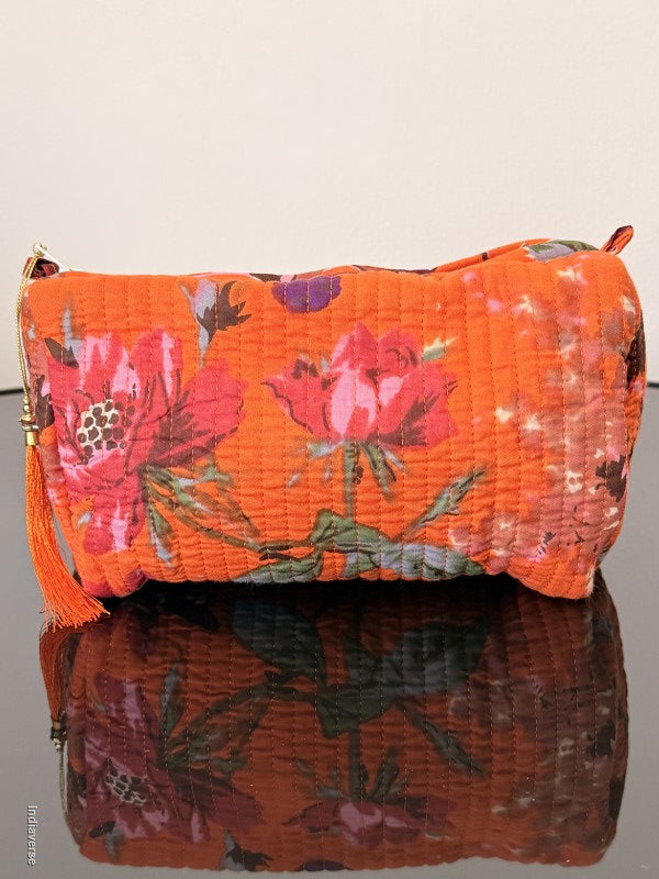 Two floral-patterned bags, one orange and one brown, on a light gray background.