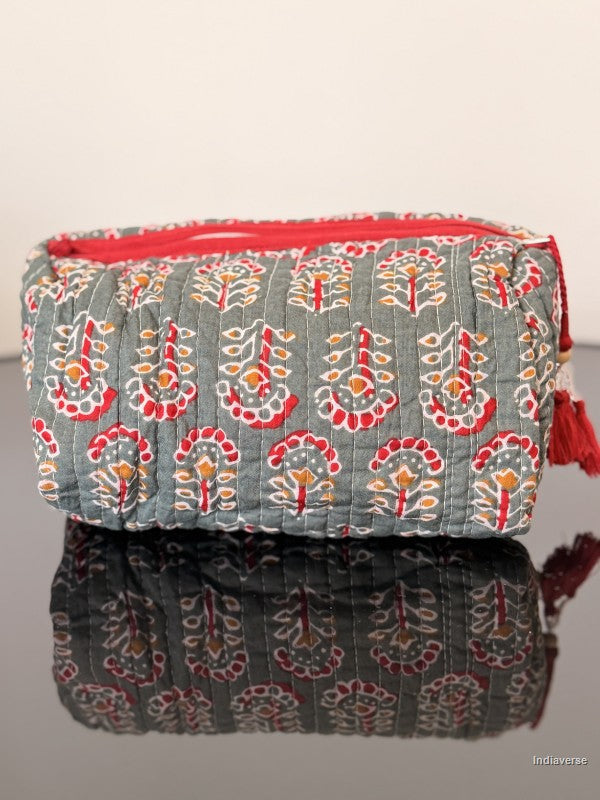Fabric pouch with floral pattern and red zipper on a gray background