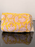 Two patterned cushions on a mannequin against a plain background