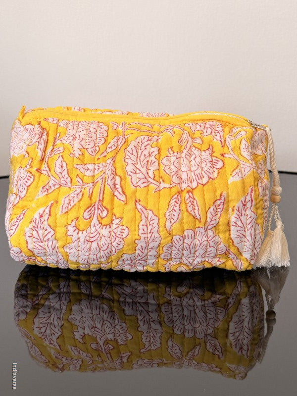Two patterned cushions on a mannequin against a plain background