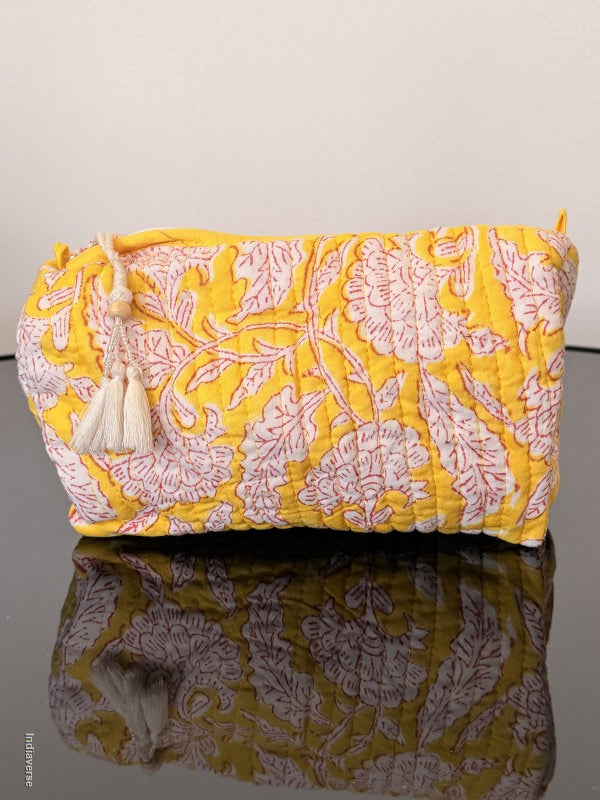 Two floral-patterned bags, one yellow and one green, on a plain background.