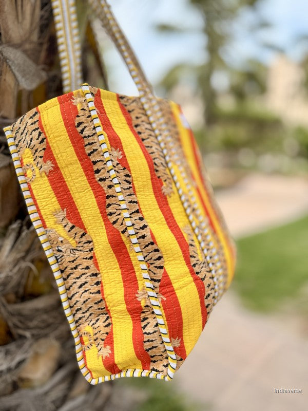 tote bag side view with tiger print hanging from a palm tree