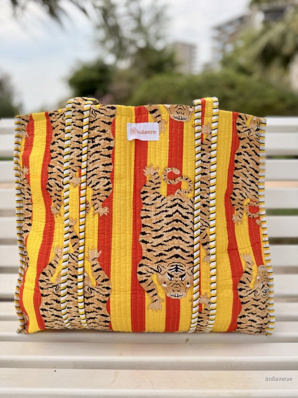 tote bag with vibrant tiger print sitting on a white bench