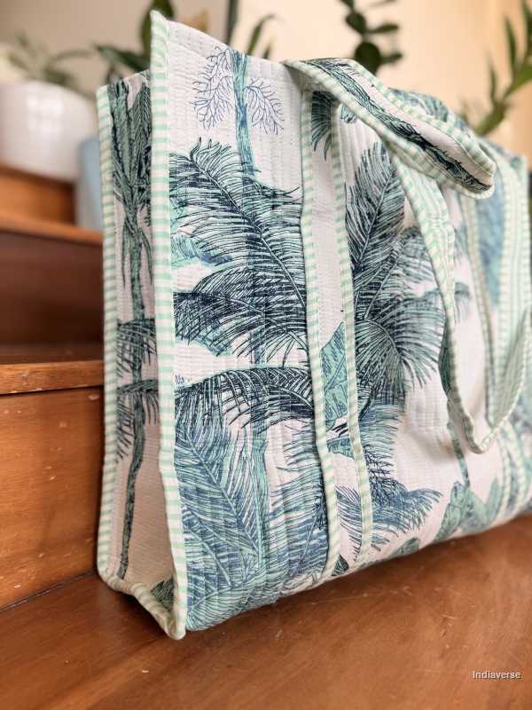 Tropical leaf patterned bag on a wooden surface