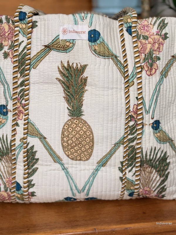 close up of the pineapple and bird design and showing the label Indiaverse