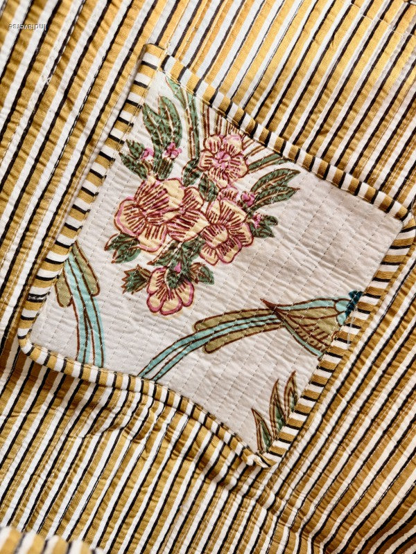 close up of inside pocket of the quilted tote bag showing stripes and bird on the pocket