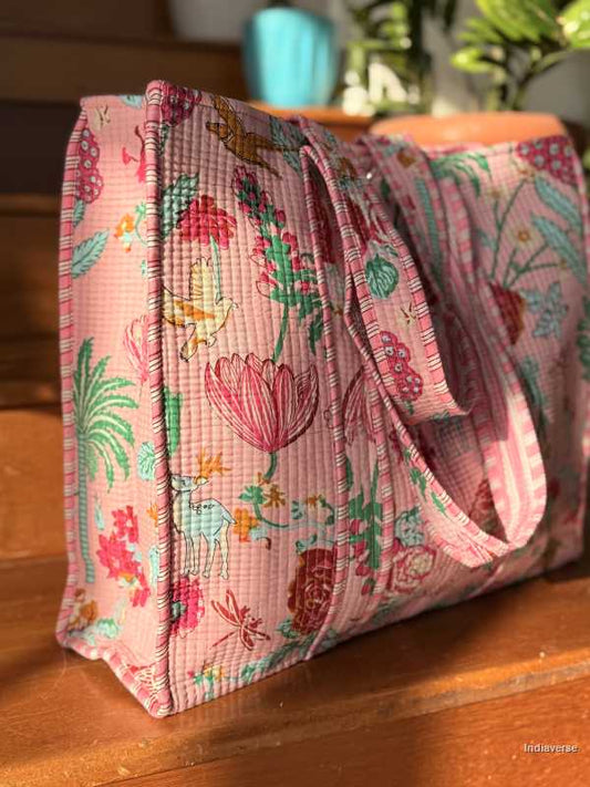 Pink floral fabric tote bag on a wooden surface