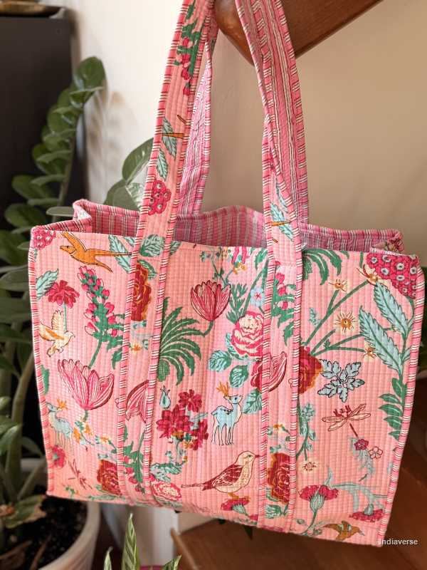 Floral patterned tote bag with a plant in the background