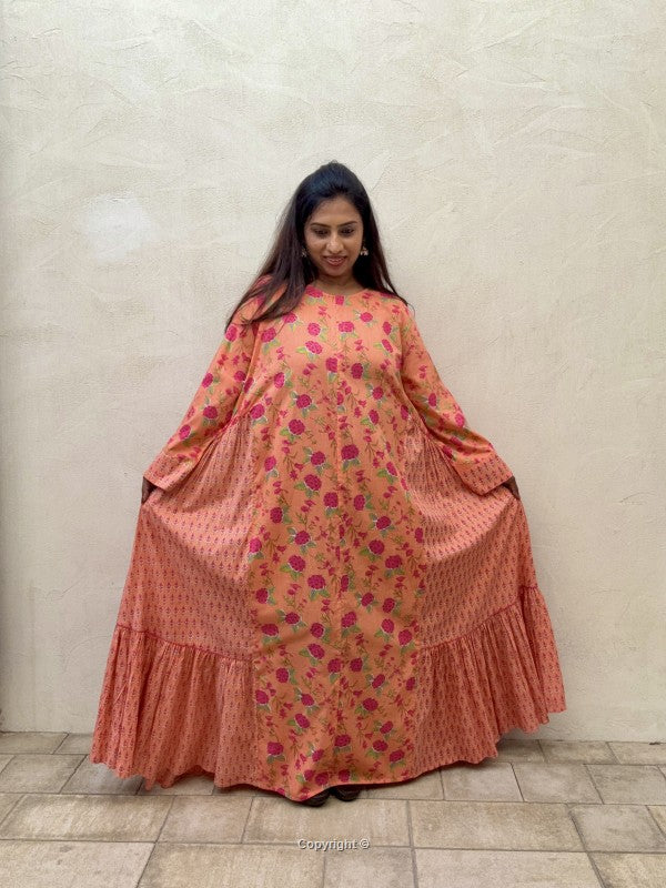 Woman wearing a floral dress with a plain background