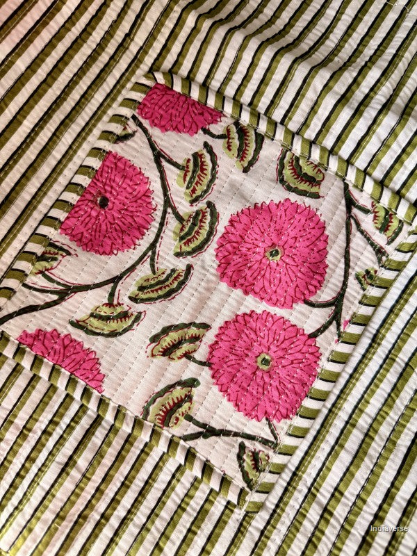 Embroidered fabric with pink flowers and green leaves on a striped background