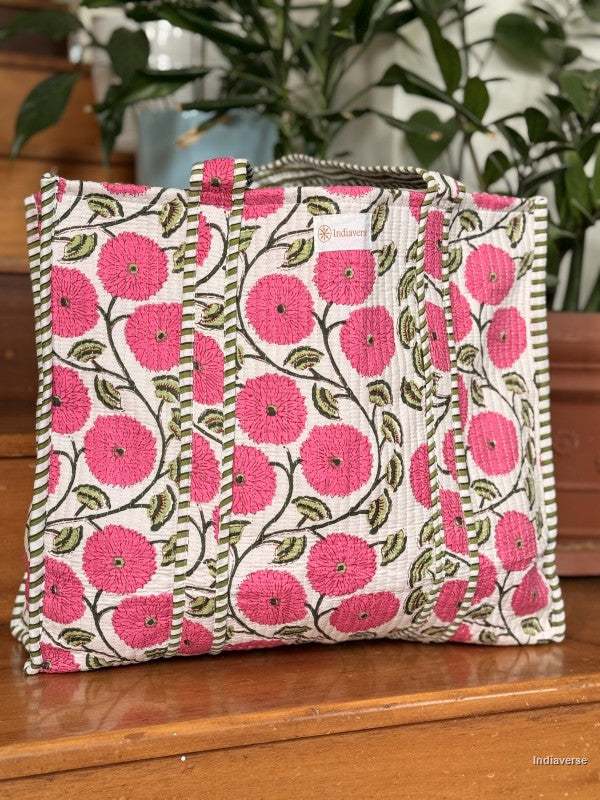 Floral patterned bag with pink flowers on a wooden surface