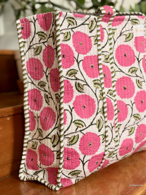 Floral patterned bag with pink flowers on a wooden surface