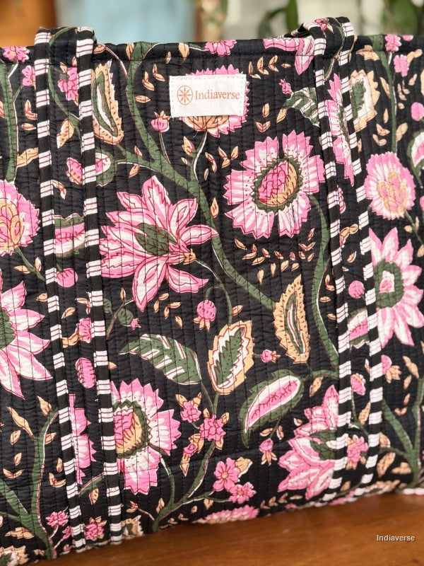 Floral-patterned fabric with a visible brand label on a wooden surface