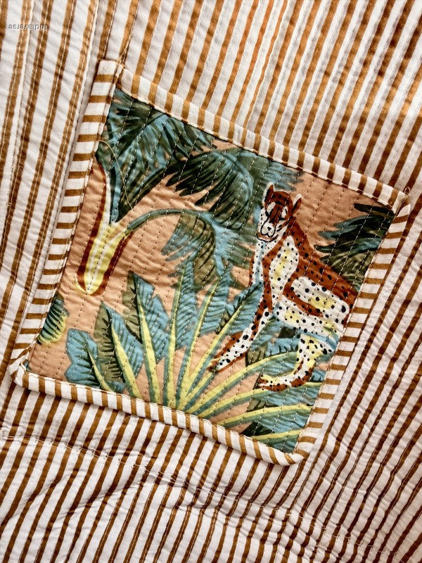 Fabric with tropical leaf pattern on a striped background