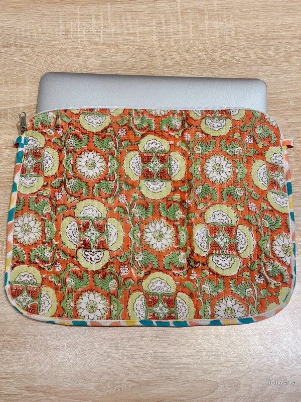 Floral patterned laptop sleeve on a wooden surface