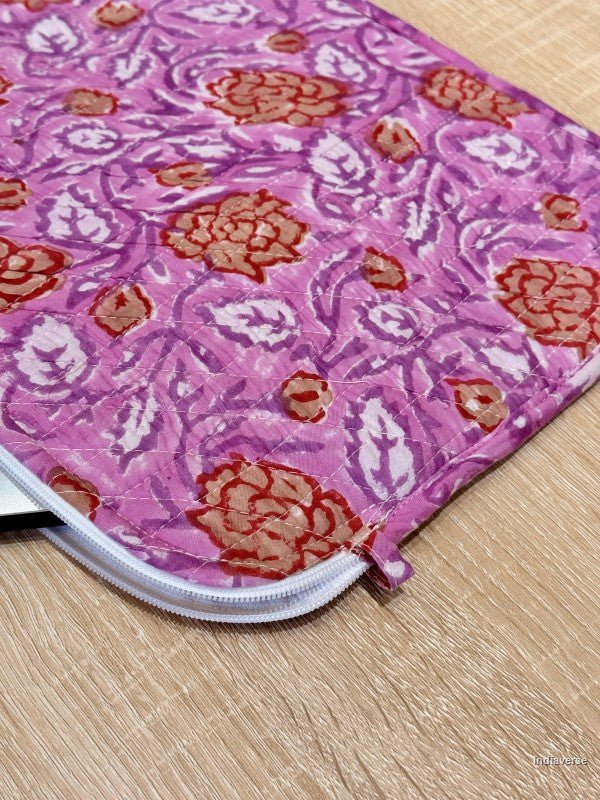 Pink floral patterned pouch on a wooden surface