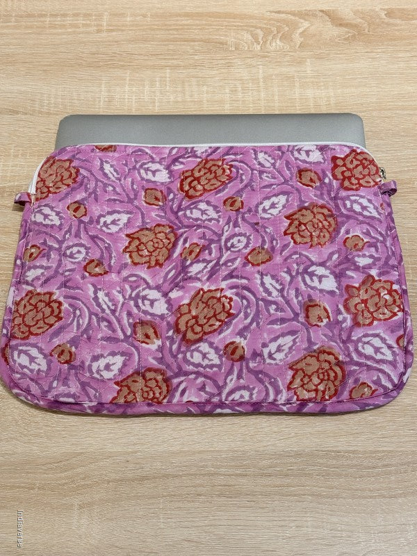 Floral patterned pink pouch on a wooden surface