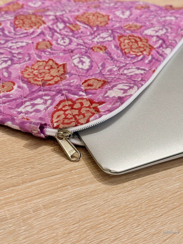 Pink floral laptop sleeve on a wooden surface