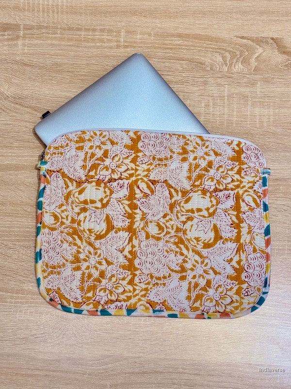 Floral patterned laptop sleeve on a wooden surface