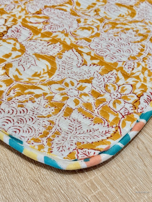 quilted laptop sleeve with floral pattern on a wooden floor