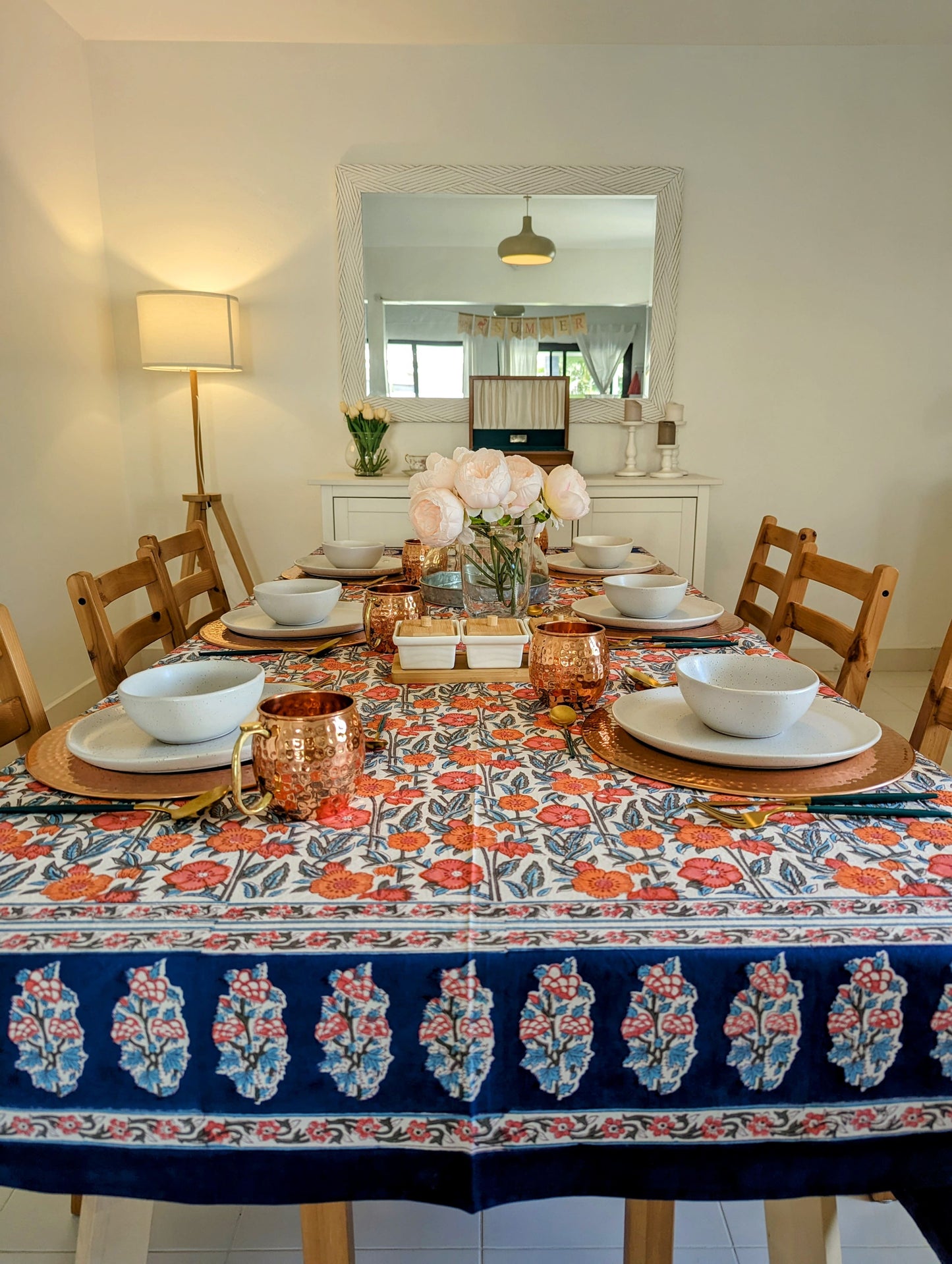 rectangular-tablecloth-for-a-6-seater-table-with-orange-flower-design-on-white-background-with-navy-blue-flower-border