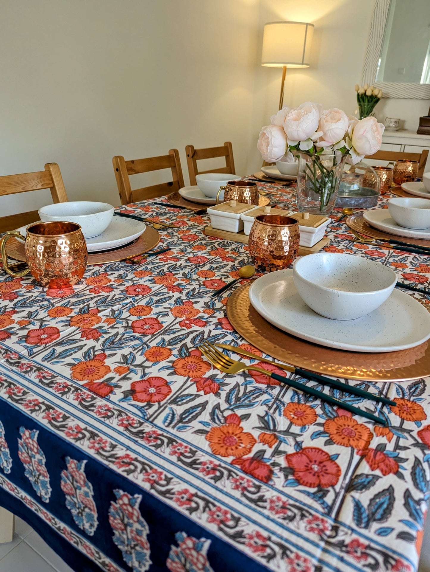 rectangular-tablecloth-for-a-6-seater-table-with-orange-flower-design-on-white-background-with-navy-blue-flower-border