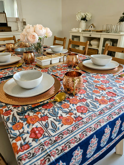 rectangular-tablecloth-for-a-6-seater-table-with-orange-flower-design-on-white-background-with-navy-blue-flower-border