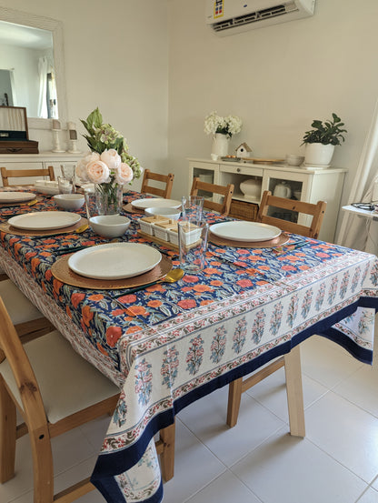 rectangular-tablecloth-for-a-6-seater-table-with-orange-flower-design-on-navy-blue-background-and-with-white-floral-border