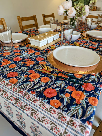 rectangular-tablecloth-for-a-6-seater-table-with-orange-flower-design-on-navy-blue-background-and-white-floral-border