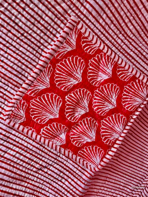 Close-up of a red and white patterned fabric with shell design inside pocket