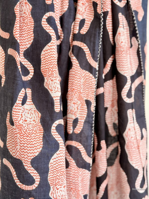 Fabric with pink cat pattern on a dark background