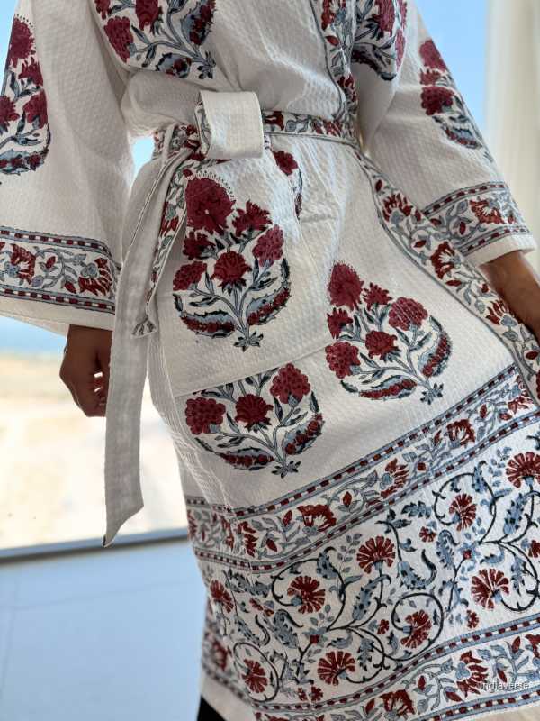 White garment with red floral patterns in a desert setting